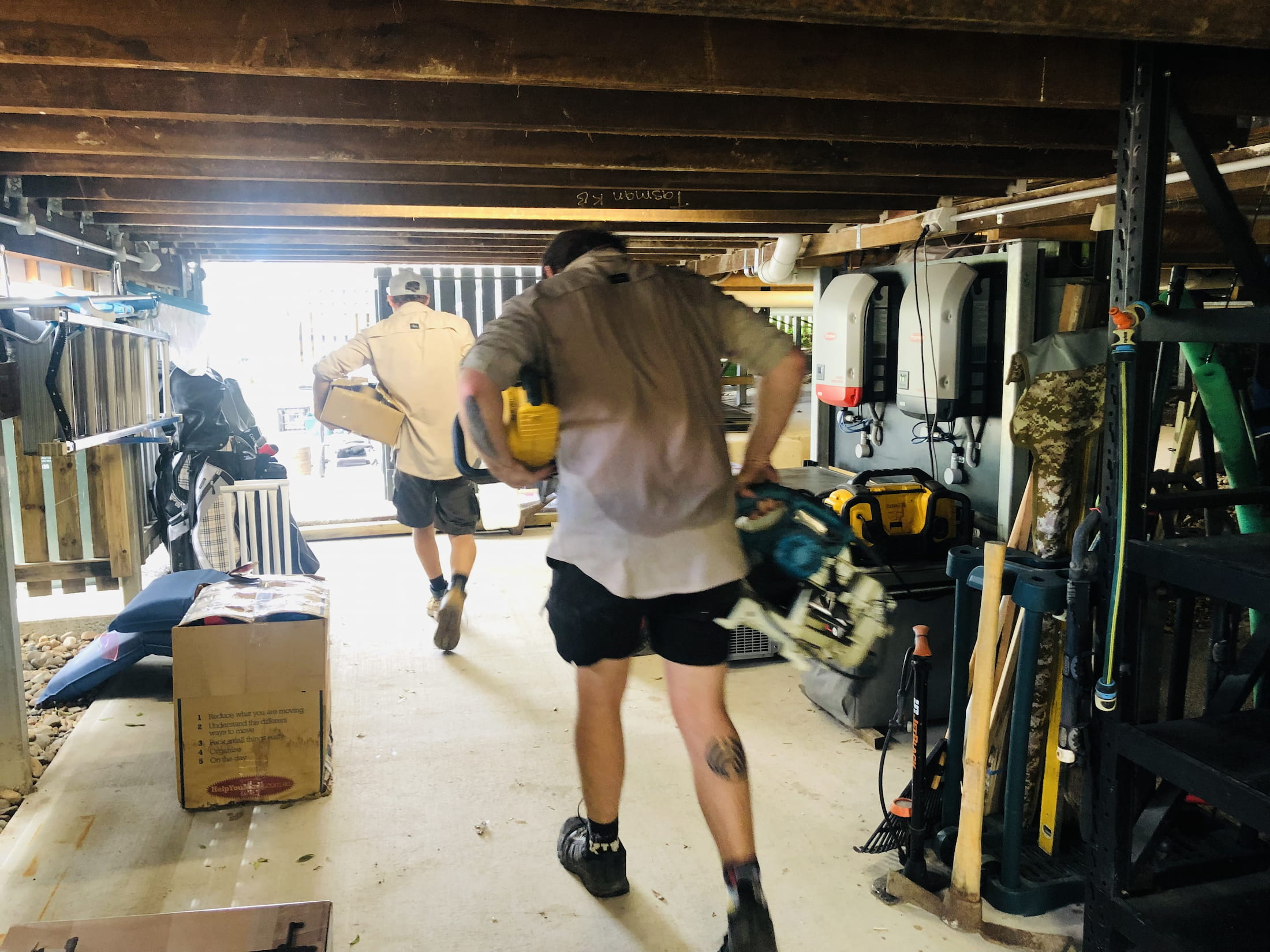 two men carrying junk