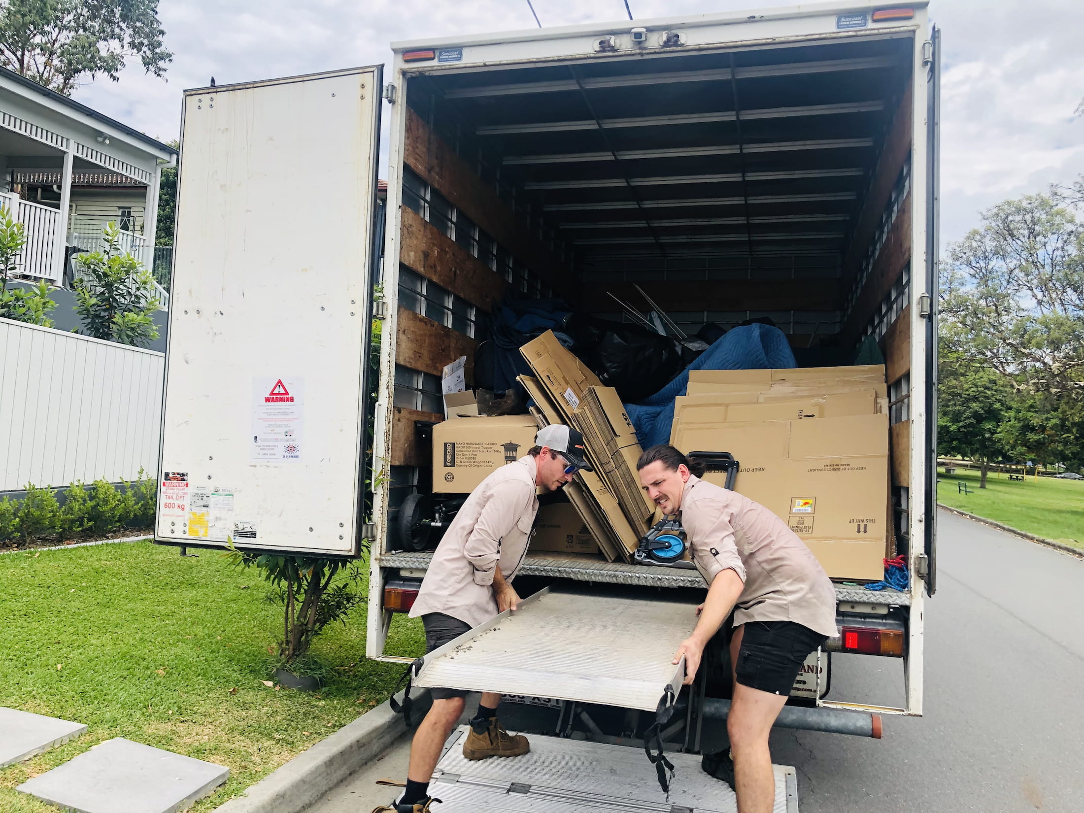 two men performing rubbish removal Buderim with a big truck