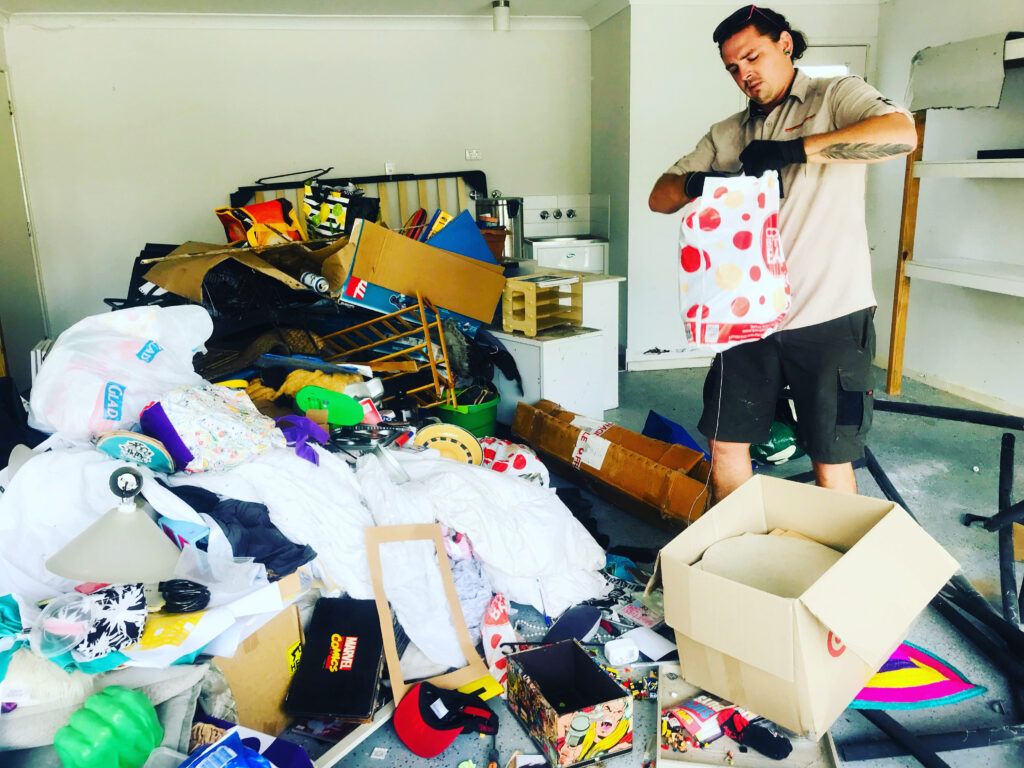 worker performing a hoarder house cleaning service